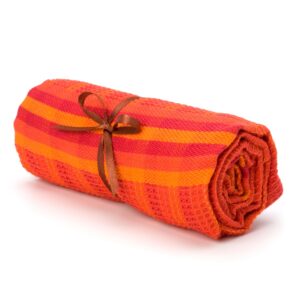 Textured high-density yoga mat on a light studio background with cobalt blue accents